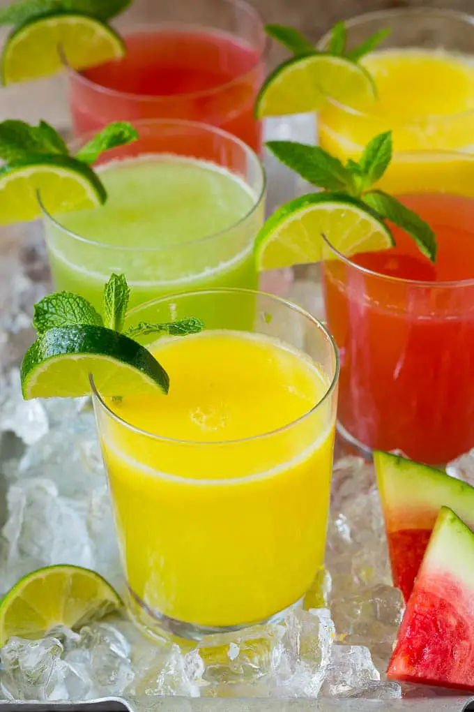 melon, strawberry and mango agua fresca garnished with a lime and mint leaves