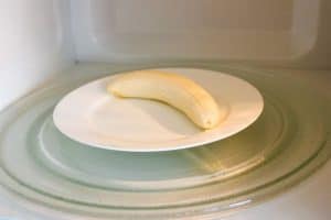 a banana that is getting ready to be ripened fast in the microwave to be used in baking
